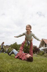 Father playing with daughter in garden - RBF005102