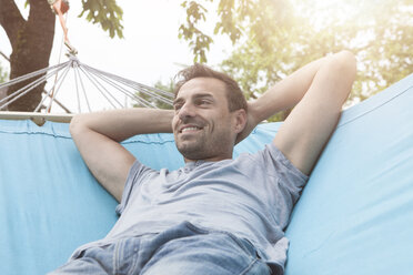 Smiling man relaxing in hammock - RBF005143