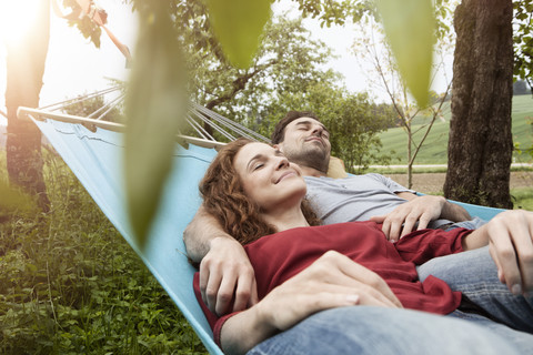 Couple relaxing in hammock stock photo