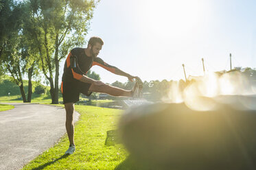 Athlete stretching at a bench - DIGF001067