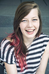 Portrait of laughing young woman with red strand of hair - TAMF000610