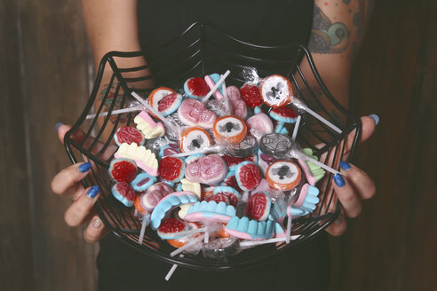 Woman offering Halloween candies, close-up - RTBF000291