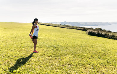 Woman doing warm up before training - MGOF002325