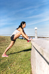 Woman doing warm up before training - MGOF002329