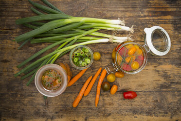 Pickled spring onions and fermented carrots in glasses - LVF005255