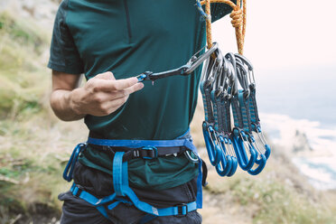 Young man preparing climbing equipment - RAEF001459