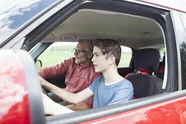 Father teaching son driving a car - RBF005150