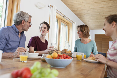 Happy family having breakfast at home - RBF005158