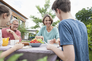 Happy family in garden having afternoon break - RBF005199