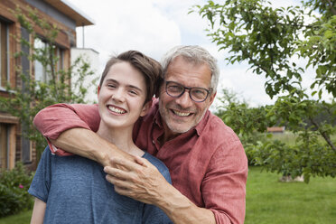 Portrait of happy father and son in garden - RBF005204