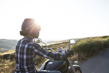 Mann fährt Motorrad in der Abenddämmerung - ABZF001149