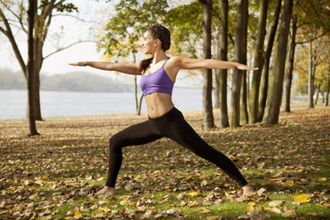 Frau in der Natur, die eine Yoga-Pose einnimmt - MFF003045