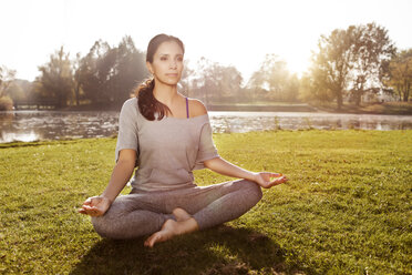 Woman relaxing in Lotus yoga pose - MFF003060