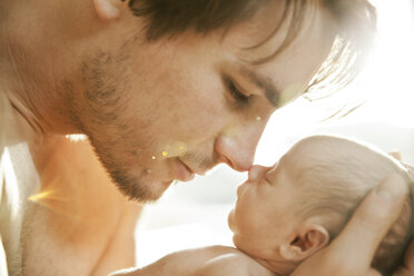 Vater nähert sich dem Gesicht seines neugeborenen Babys - MFF003194