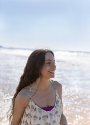 Happy young woman on the beach - MGOF002383