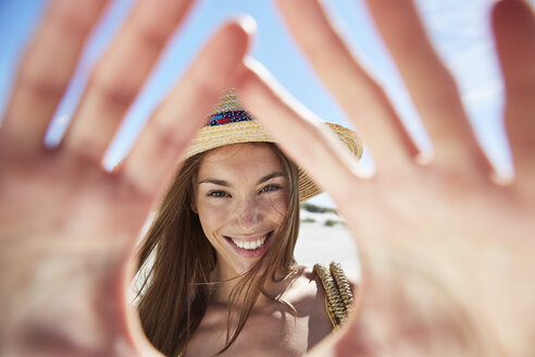 Portrait of smiling young woman on the beach - SRYF000011