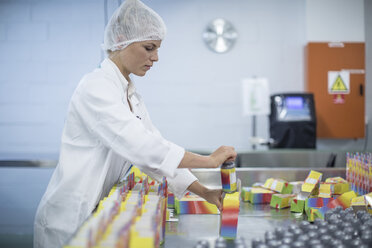 Woman packing flasks in medical factory - ZEF010103