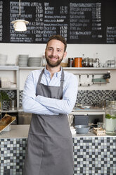 Portrait of smiling barista in a cafe - WESTF021647