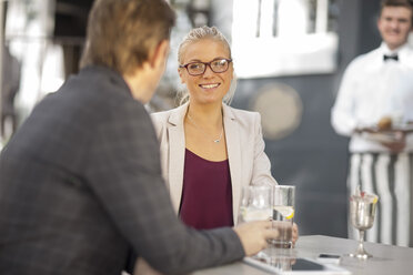 Woman smiling at man at outdoor restaraunt - ZEF010265