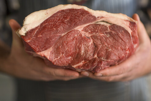 Metzger hält ein Stück rohes Fleisch - ZEF010291