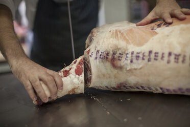 Butcher jointing carcass in butchery - ZEF010324