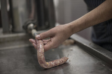 Butcher making sausages in butchery - ZEF010331