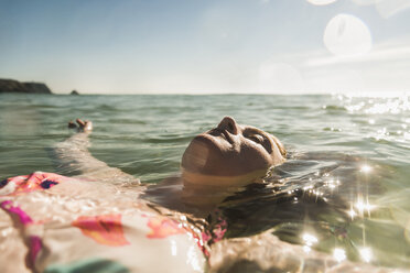 Teenage girl floating in the sea - UUF08431