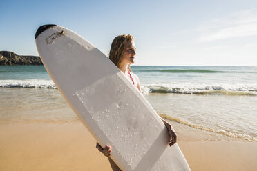 Teenager-Mädchen hält Surfbrett am Meer - UUF08445