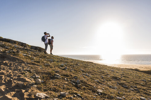 France, Bretagne, Finistere, Crozon peninsula, couple during beach hiking - UUF08458