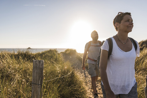 France, Bretagne, Finistere, Crozon peninsula, couple during beach hiking stock photo