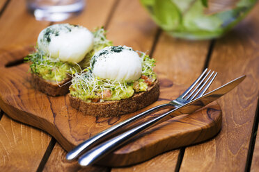 Slices of toast with mashed avocado, boiled egg and sprouts - KNTF00495