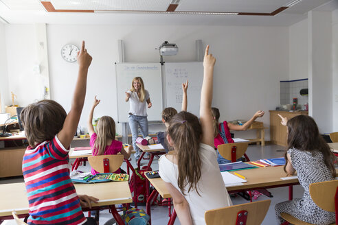 Active pupils raising their hands in class - SARF02896