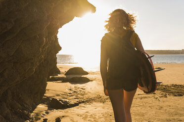 Teenager-Mädchen am Strand mit Surfbrett - UUF08522