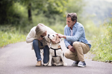 Senior couple with dog in nature - HAPF00872