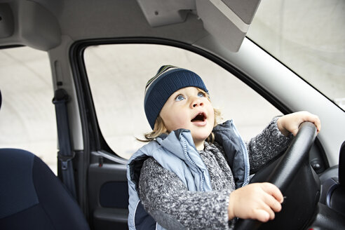 Little boy sitting at steering wheel of car - FSF00458
