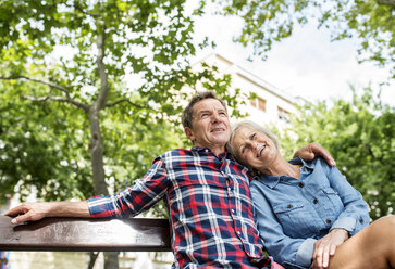 Senior couple relaxing together on bench - HAPF00916