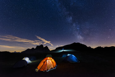 Italy, Dolomites, Milky Way over Monte Pelmo with tents of camp in the foreground - LOMF00399
