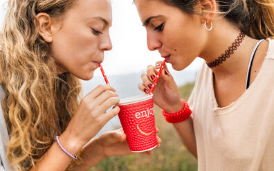 Two best friends sharing a drink - MGOF02462