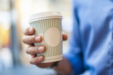 Hand holding takeaway coffee - DIGF01285