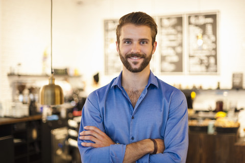 Portrait of confident young man in a cafe stock photo