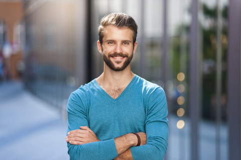 Portrait of smiling young man in the city stock photo