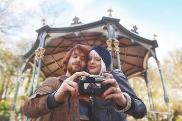Young couple taking a selfie in front of pavilion - RTBF00388