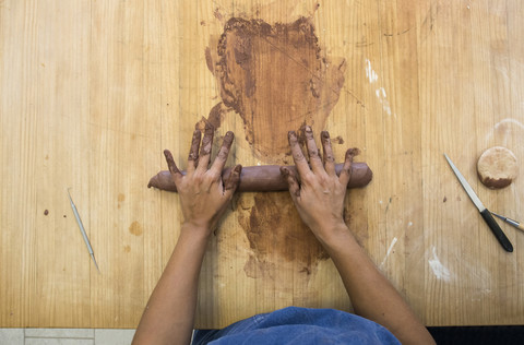 Hands of a woman working with clay in a ceramics workshop stock photo