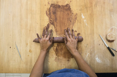 Hands of a woman working with clay in a ceramics workshop - ABZF01265