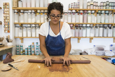 Woman working with clay in a ceramics workshop - ABZF01266