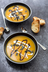 Creamed pumpkin soup in black bowl - SARF02916