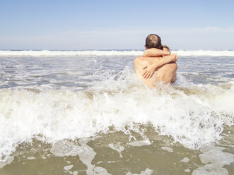 Couple at the beach embracing in the water - LAF01743