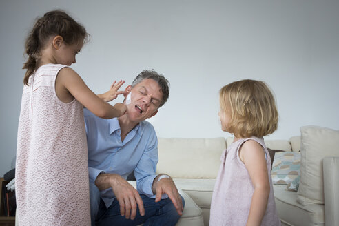 Daughter sticking band aid on father's cheek - JTLF00114