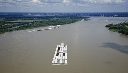 USA, Tennessee, Aerial photograph of tug and barges heading up the Mississippi River near Memphis - BCDF00050