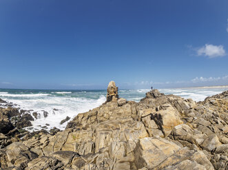 France, Bretagne, Finistere, Man standing at Atlantic coast - LAF01758